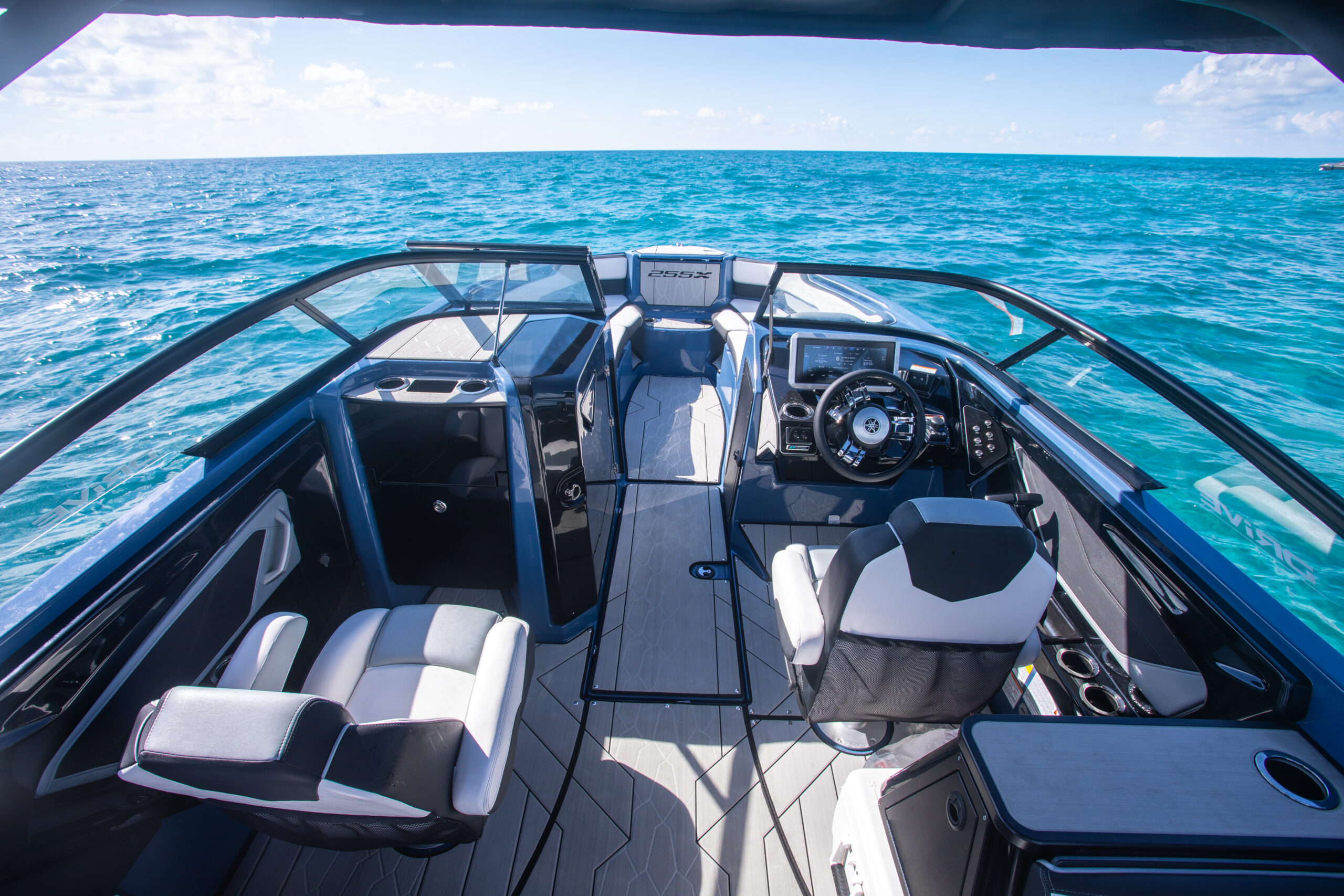 Close-up interior of a Miami wakeboard boat with plush seats and cup holders